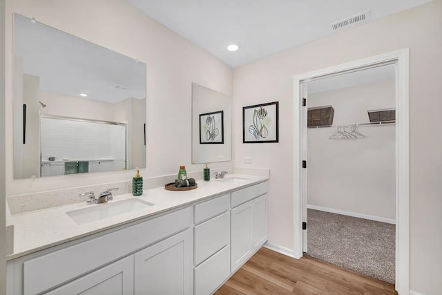 311 Snowdrop Ln, Elgin, IL 60124 - full bath with double vanity, wood finished floors, an enclosed shower, and a walk in closet