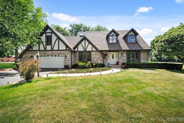 4S064 Hazelcrest Dr, Sugar Grove, IL 60554 - tudor home featuring driveway, a front lawn, stucco siding, and a garage
