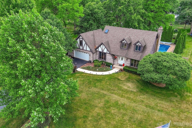 4S064 Hazelcrest Dr, Sugar Grove, IL 60554 - view of front of home with stone siding, driveway, a front lawn, and a chimney