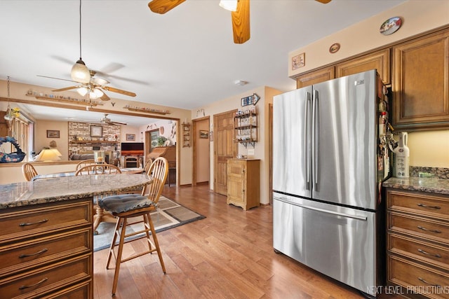 4S064 Hazelcrest Dr, Sugar Grove, IL 60554 - kitchen with freestanding refrigerator, a ceiling fan, brown cabinets, and light wood finished floors