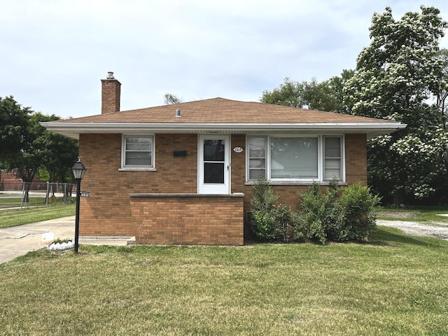 664 E 142nd St, Dolton, IL 60419 - view of front of house featuring a chimney, brick siding, and roof with shingles