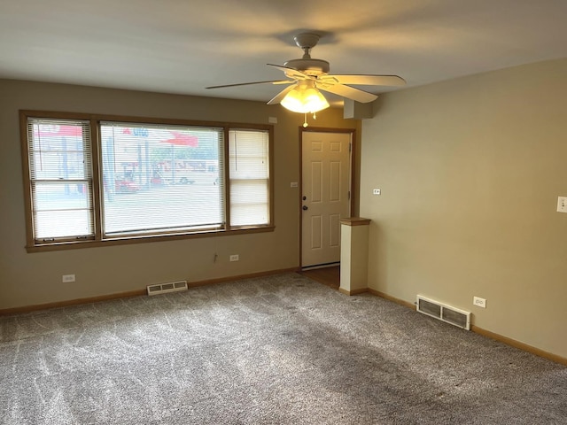 664 E 142nd St, Dolton, IL 60419 - carpeted empty room with a ceiling fan and healthy amount of natural light