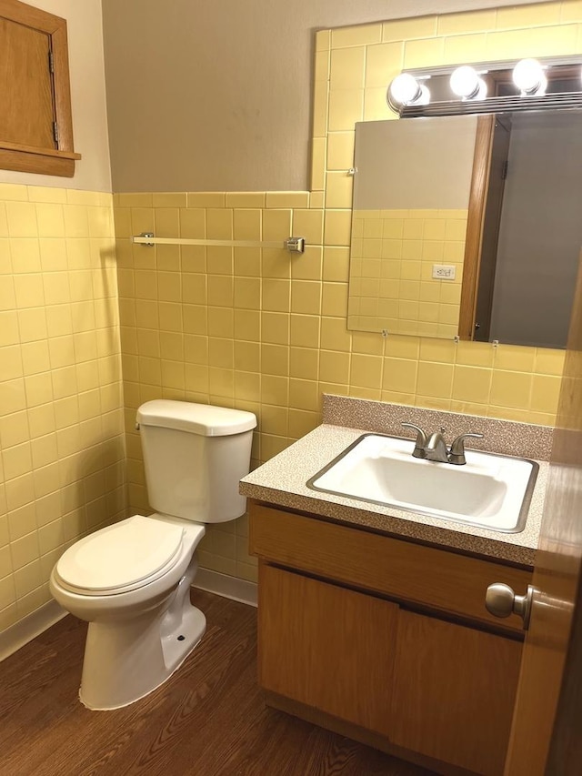 664 E 142nd St, Dolton, IL 60419 - half bath featuring tile walls, wood finished floors, and vanity
