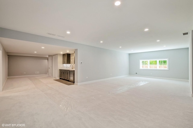 unfurnished room with recessed lighting and light colored carpet