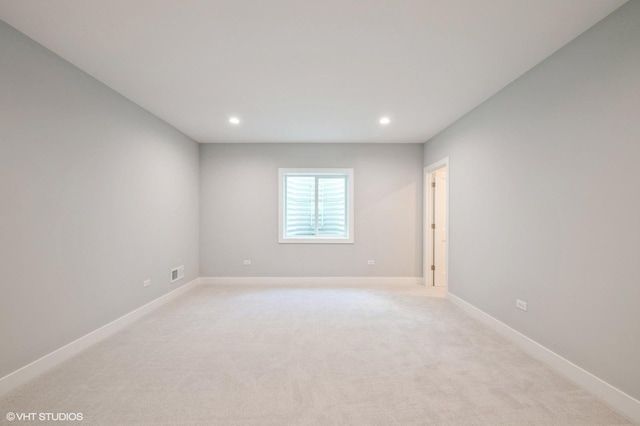 empty room featuring recessed lighting and light carpet