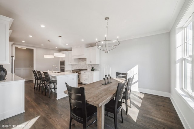 dining space with a chandelier, ornamental molding, dark wood-style flooring, and recessed lighting