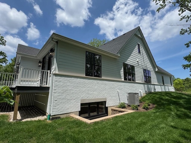 view of property exterior featuring a yard and a wooden deck