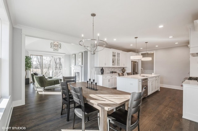 dining room with recessed lighting, a chandelier, dark wood-style flooring, and ornamental molding