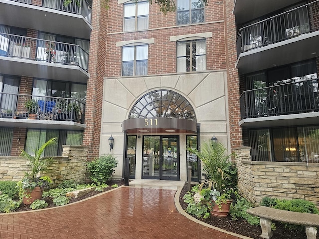 511 Aurora Ave Unit 410, Naperville, IL 60540 - doorway to property with stone siding, brick siding, and french doors