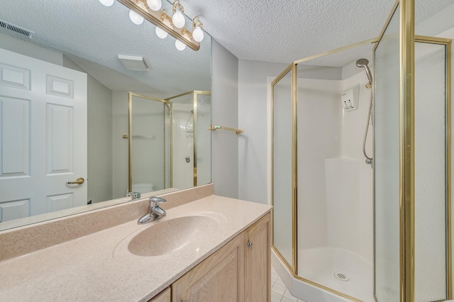511 Aurora Ave Unit 410, Naperville, IL 60540 - bathroom with a stall shower, vanity, a textured ceiling, and tile patterned flooring