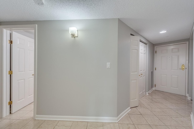 511 Aurora Ave Unit 410, Naperville, IL 60540 - hall featuring light tile patterned floors, a textured ceiling, and recessed lighting