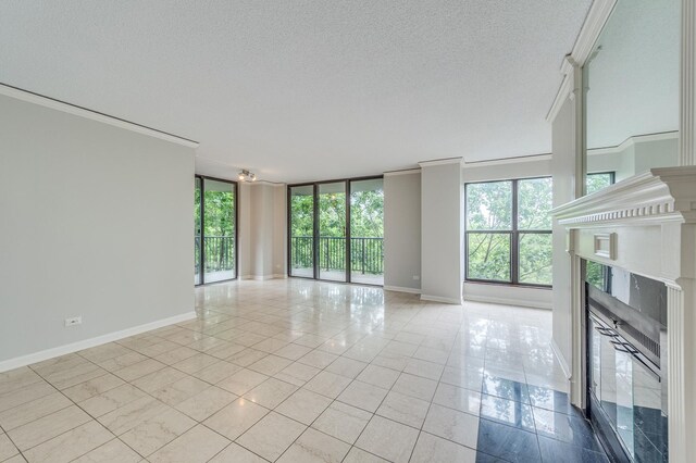 511 Aurora Ave Unit 410, Naperville, IL 60540 - unfurnished living room featuring a fireplace, crown molding, a textured ceiling, tile patterned floors, and expansive windows