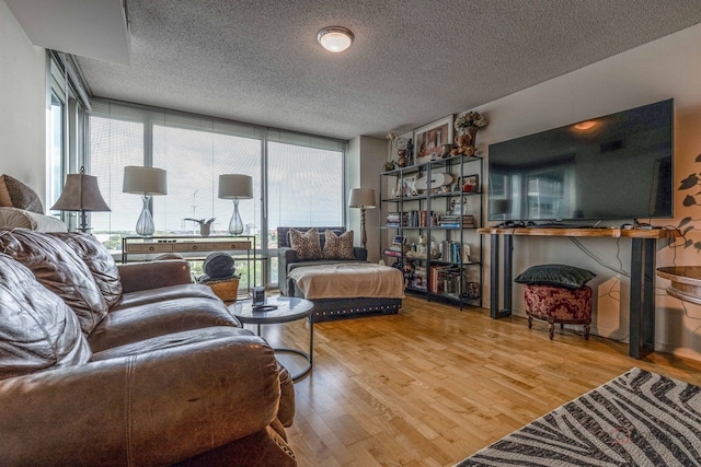 9655 Woods Dr Unit 1009, Skokie, IL 60077 - living room with healthy amount of natural light, wood finished floors, a wall of windows, and a textured ceiling