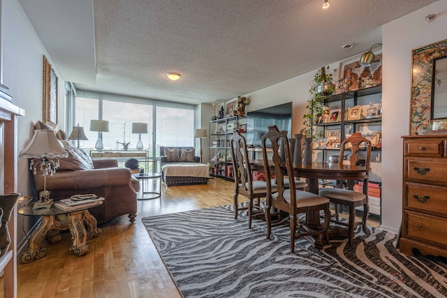 9655 Woods Dr Unit 1009, Skokie, IL 60077 - dining room featuring a textured ceiling, wood finished floors, and floor to ceiling windows