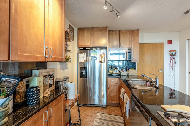 9655 Woods Dr Unit 1009, Skokie, IL 60077 - kitchen with appliances with stainless steel finishes, a textured ceiling, brown cabinets, light tile patterned flooring, and dark stone countertops