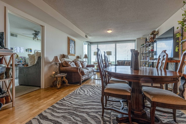 9655 Woods Dr Unit 1009, Skokie, IL 60077 - dining room with a textured ceiling, light wood finished floors, a ceiling fan, and floor to ceiling windows