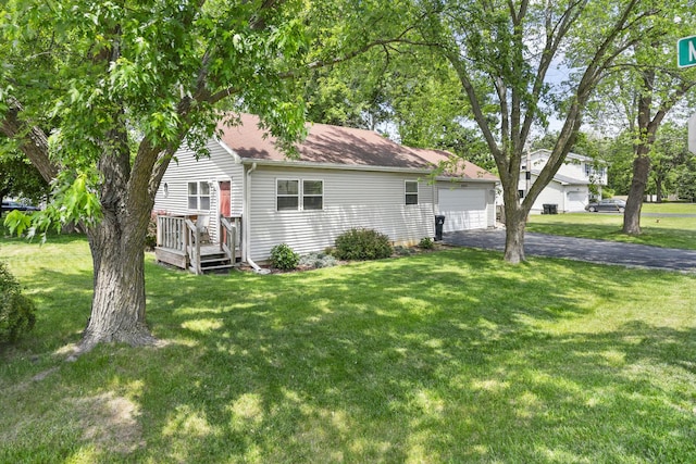 2602 Michael St, Wonder Lake, IL 60097 - view of front facade with a front lawn, a garage, a shingled roof, and driveway