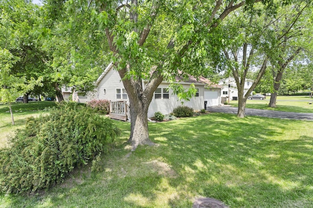2602 Michael St, Wonder Lake, IL 60097 - view of side of property with asphalt driveway, a garage, and a yard