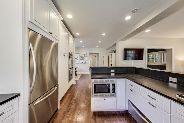 934 Jackson Ave, River Forest, IL 60305 - kitchen featuring stainless steel appliances, dark countertops, recessed lighting, white cabinets, and dark wood finished floors