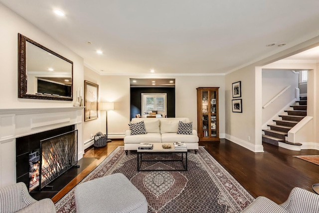 934 Jackson Ave, River Forest, IL 60305 - living area featuring wood finished floors, stairway, a warm lit fireplace, a baseboard heating unit, and crown molding
