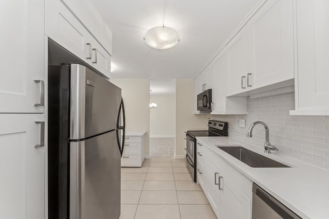 1605 E Central Rd Unit 411B, Arlington Heights, IL 60005 - kitchen with stainless steel appliances, light tile patterned floors, white cabinetry, backsplash, and light countertops