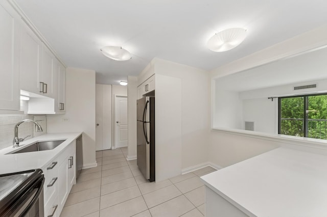 1605 E Central Rd Unit 411B, Arlington Heights, IL 60005 - kitchen featuring freestanding refrigerator, light tile patterned floors, white cabinetry, and light countertops