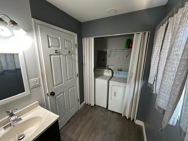 420 Wabash St, Wilmington, IL 60481 - bathroom featuring washing machine and clothes dryer, electric panel, vanity, and wood finished floors