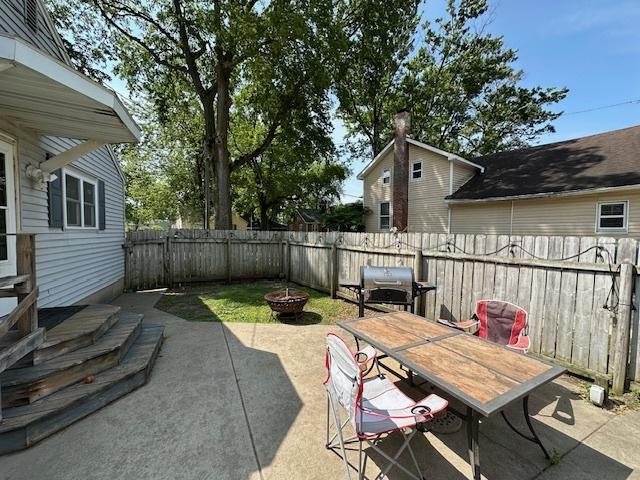 420 Wabash St, Wilmington, IL 60481 - fenced backyard with grilling area, an outdoor fire pit, a patio, and outdoor dining space