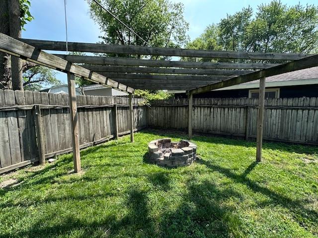 420 Wabash St, Wilmington, IL 60481 - fenced backyard with an outdoor fire pit and a pergola