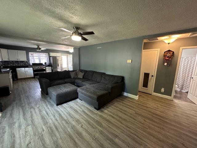 420 Wabash St, Wilmington, IL 60481 - living area with ceiling fan, a textured ceiling, and wood finished floors