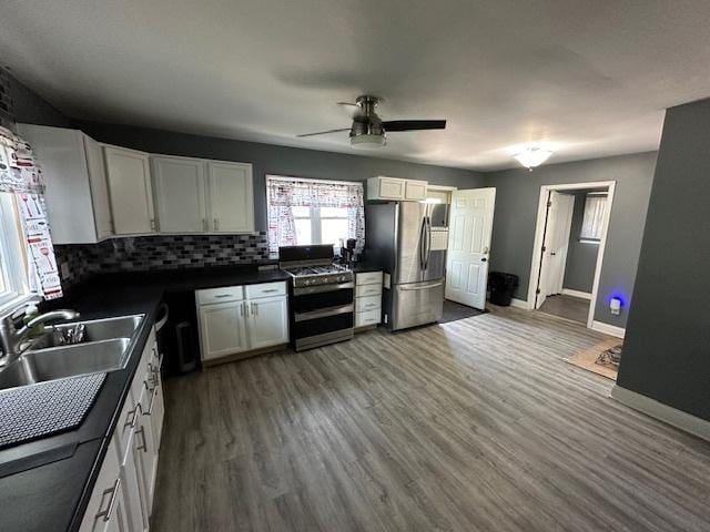 420 Wabash St, Wilmington, IL 60481 - kitchen with stainless steel appliances, a ceiling fan, decorative backsplash, wood finished floors, and white cabinetry