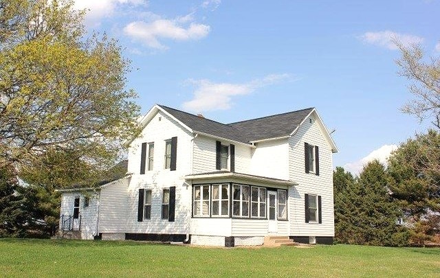 17218 Lincoln Rd, Morrison, IL 61270 - view of side of home with a lawn and a sunroom