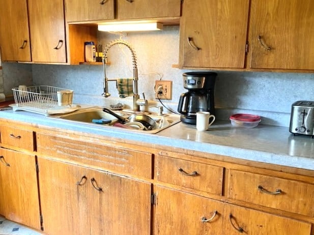 17218 Lincoln Rd, Morrison, IL 61270 - kitchen featuring light countertops, tasteful backsplash, and brown cabinetry