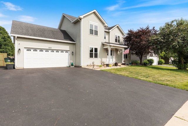 509 Magnolia Dr, North Aurora, IL 60542 - traditional-style house with driveway, a garage, and a front yard