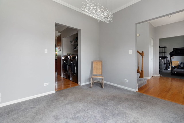 509 Magnolia Dr, North Aurora, IL 60542 - spare room featuring washer and clothes dryer, stairs, carpet flooring, crown molding, and a chandelier
