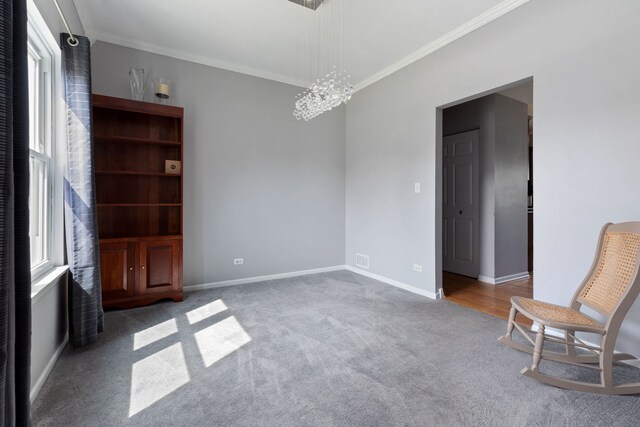 509 Magnolia Dr, North Aurora, IL 60542 - carpeted spare room featuring ornamental molding and a chandelier