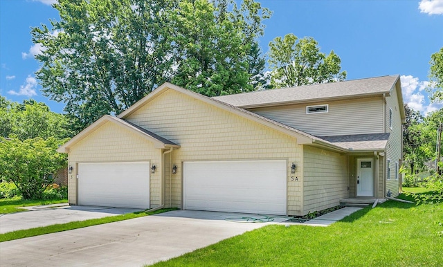 5 Montclair Rd Unit A, Urbana, IL 61801 - view of property featuring an attached garage, concrete driveway, a front yard, and a shingled roof