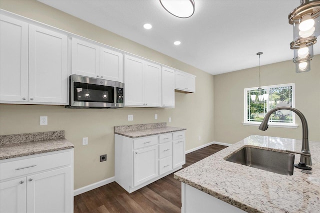 5 Montclair Rd Unit A, Urbana, IL 61801 - kitchen featuring stainless steel microwave, dark wood finished floors, light stone counters, white cabinets, and recessed lighting