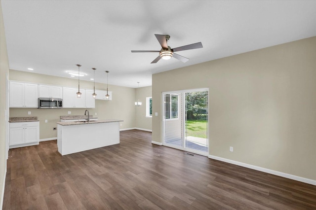 5 Montclair Rd Unit A, Urbana, IL 61801 - kitchen with stainless steel microwave, open floor plan, dark wood-style floors, and recessed lighting