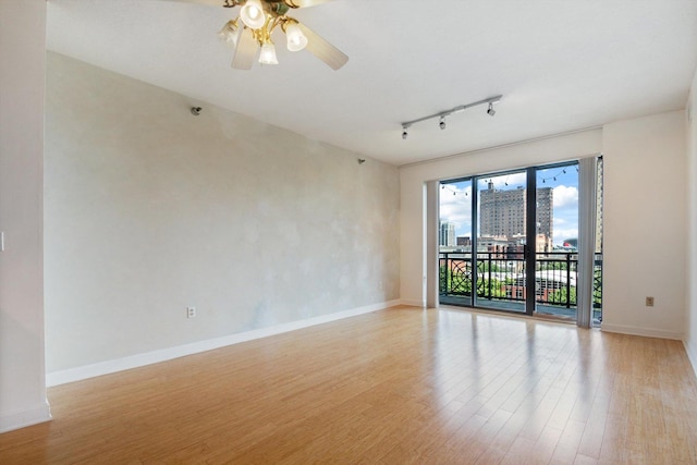 5 E 14th Pl Unit 602, Chicago, IL 60605 - spare room featuring track lighting, light wood-type flooring, a ceiling fan, and a view of city