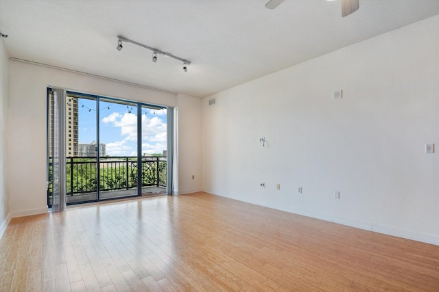 5 E 14th Pl Unit 602, Chicago, IL 60605 - unfurnished room featuring rail lighting, light wood-style flooring, and a ceiling fan