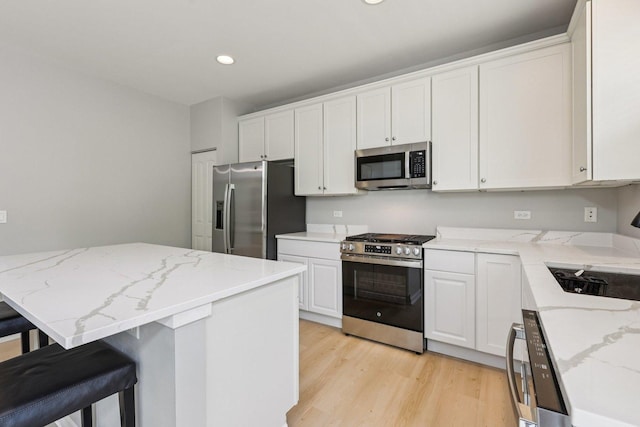 5608 Cambridge Way, Hanover Park, IL 60133 - kitchen featuring stainless steel appliances, light wood-style flooring, white cabinetry, recessed lighting, and a breakfast bar