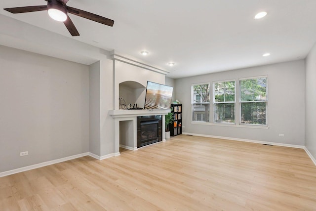 5608 Cambridge Way, Hanover Park, IL 60133 - unfurnished living room with light wood finished floors, a fireplace, a ceiling fan, and recessed lighting