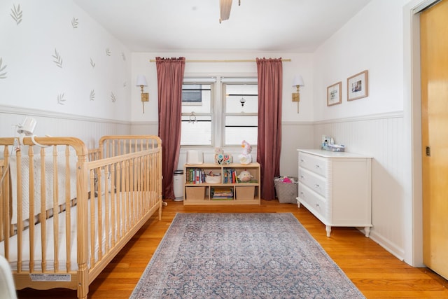 5660 N Rogers Ave, Chicago, IL 60646 - bedroom featuring wainscoting and light wood-style floors
