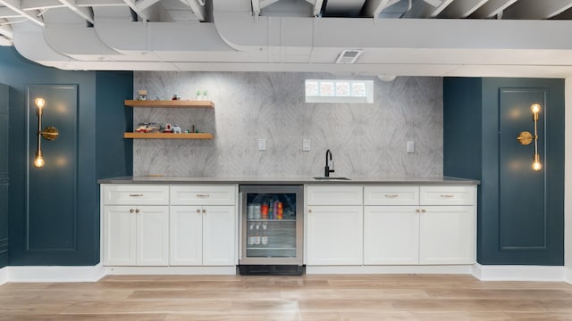 5660 N Rogers Ave, Chicago, IL 60646 - indoor wet bar with beverage cooler, light wood-type flooring, and decorative backsplash