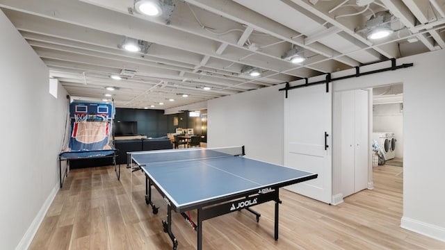 5660 N Rogers Ave, Chicago, IL 60646 - game room with washing machine and dryer, light wood-type flooring, and a barn door
