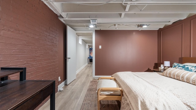 5660 N Rogers Ave, Chicago, IL 60646 - bedroom featuring brick wall and light wood-style floors