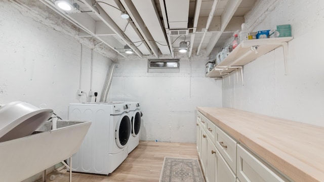 5660 N Rogers Ave, Chicago, IL 60646 - laundry room with independent washer and dryer, cabinet space, and light wood-type flooring