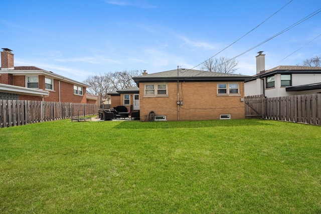 5660 N Rogers Ave, Chicago, IL 60646 - rear view of house with a fenced backyard, brick siding, and a chimney