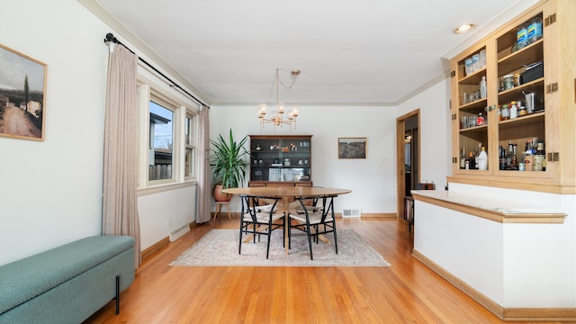 5660 N Rogers Ave, Chicago, IL 60646 - dining space featuring a chandelier and light wood-style floors